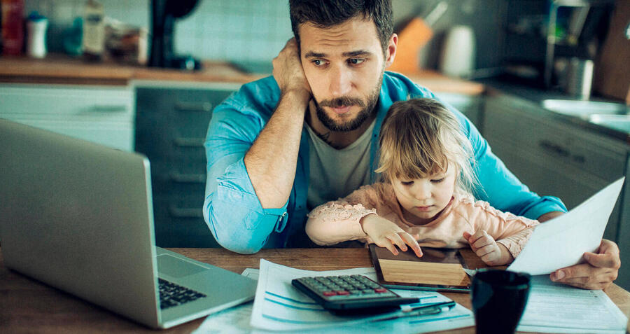 Man with a child trying to work