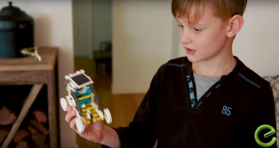 Boy showing solar powered toy car