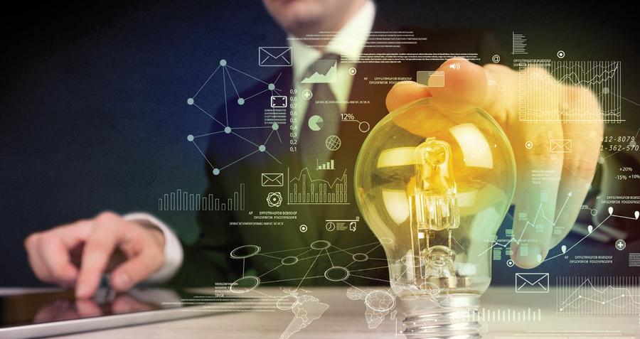 A man in a business suit touching a lightbulb